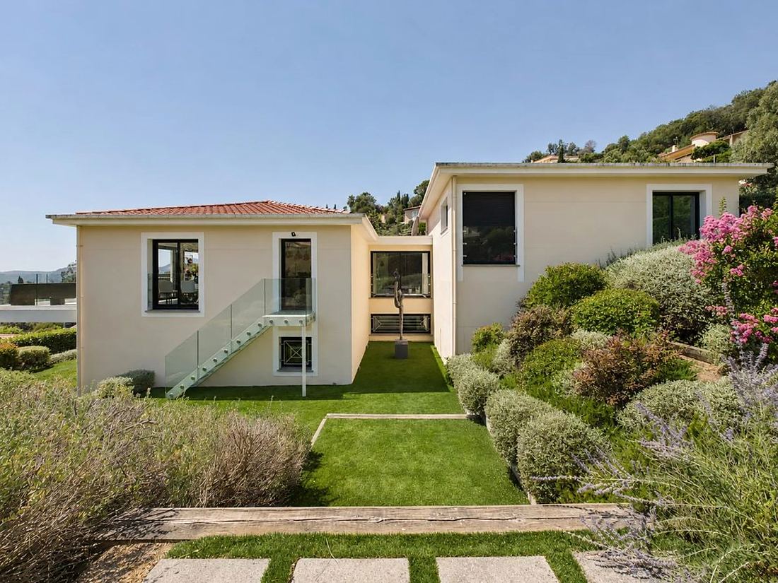 Rear elevation of the villa with lawn between the two volumes